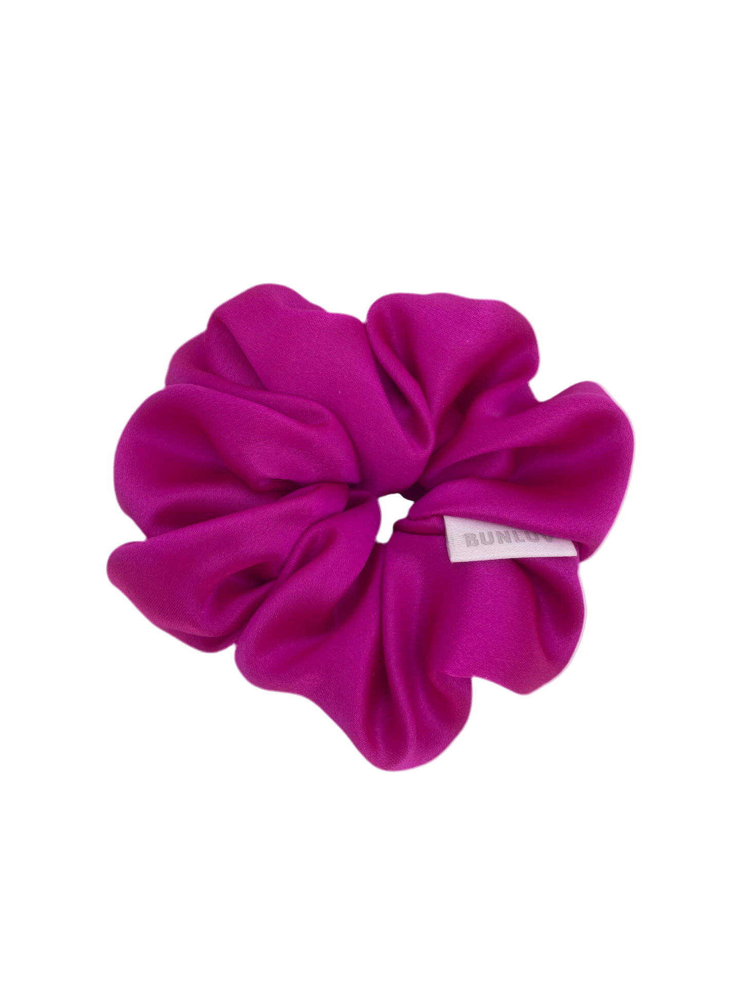 Pink scrunchie with a brand label on a white background