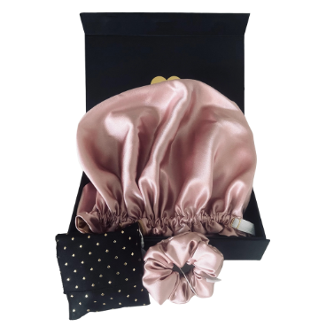 Pink satin hair bonnet and matching pouch on a white background