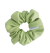 Light green scrunchie with a brand label on a white background