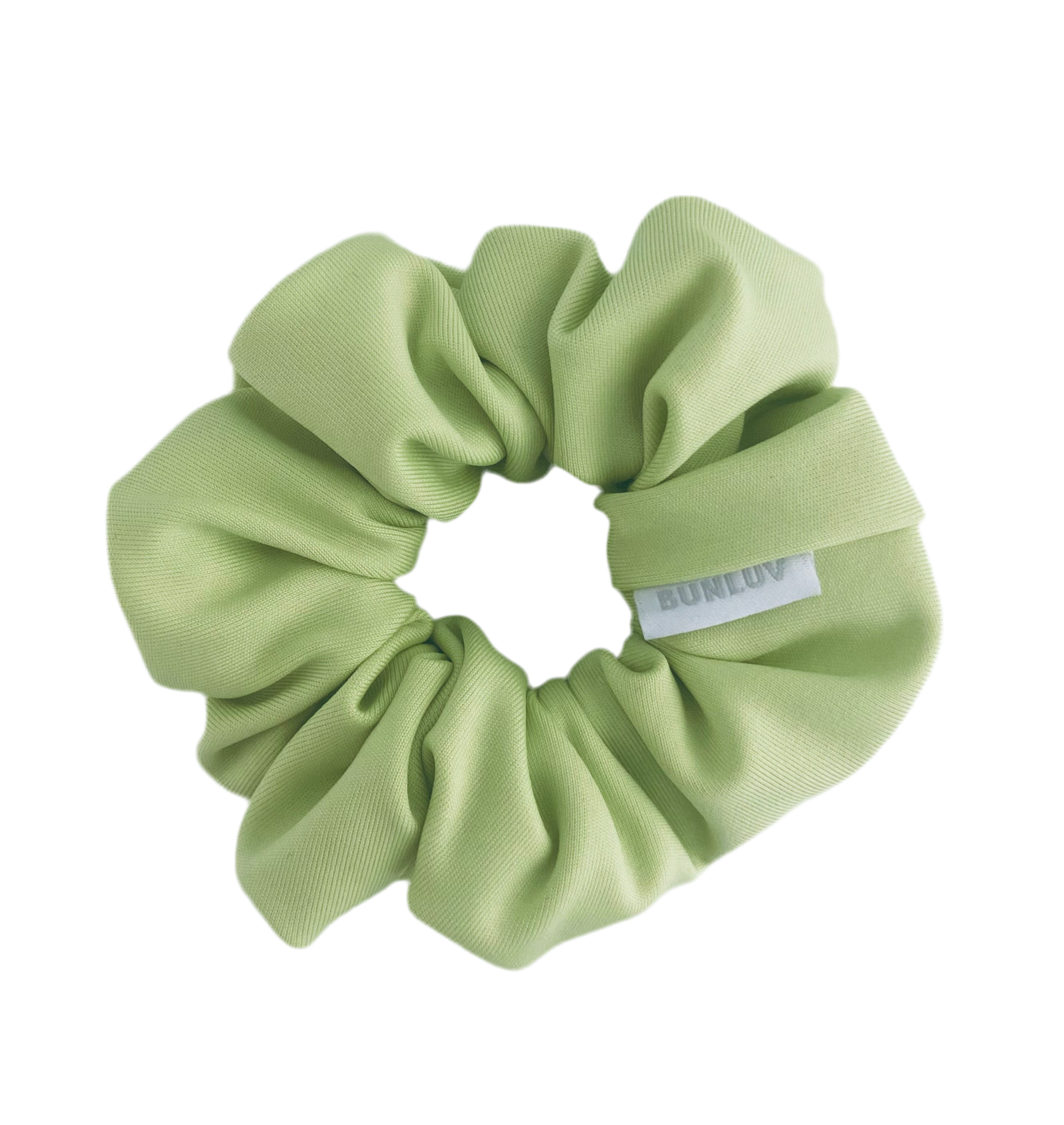 Light green scrunchie with a brand label on a white background