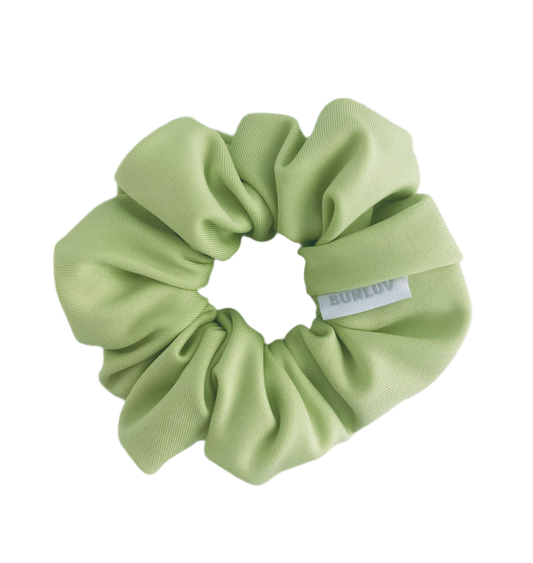Light green scrunchie with a brand label on a white background