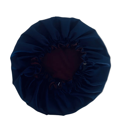 dark chocolate and navy blue satin hair bonnet on a white table BUNLUV brand 