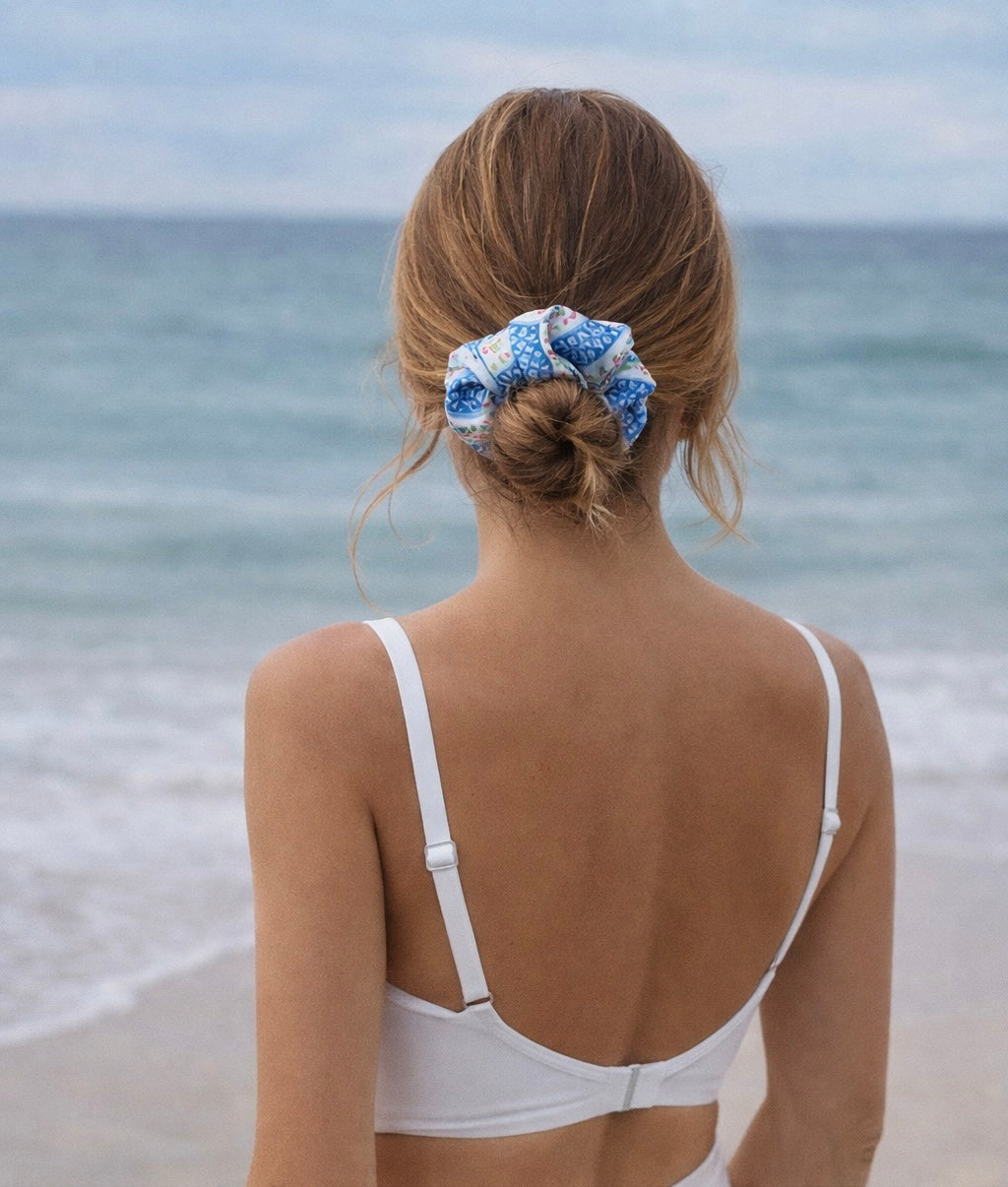Woman with a mediterranean swim scrunchie in her hair at the beach
