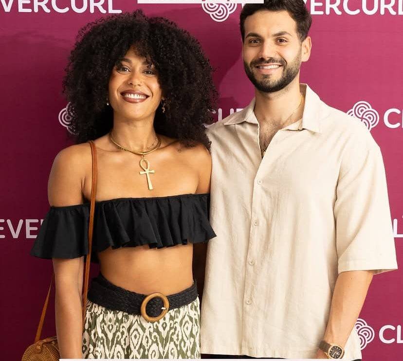 couple standing infront of clever curl event wall