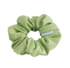Light green scrunchie with a brand label on a white background