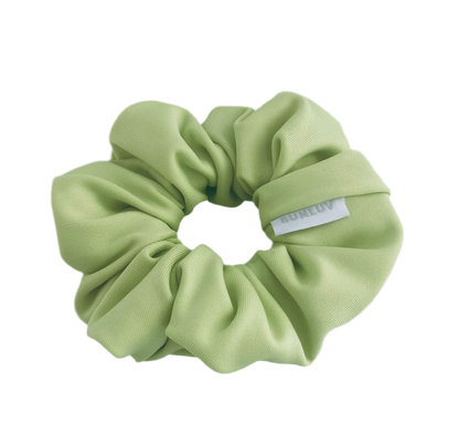 Light green scrunchie with a brand label on a white background