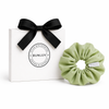 Light green school scrunchie by BUNLUV, shown with gift box