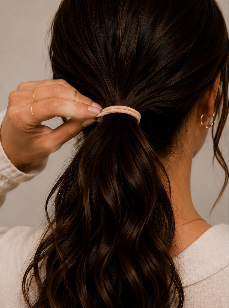 woman holding onto elastic hair tie