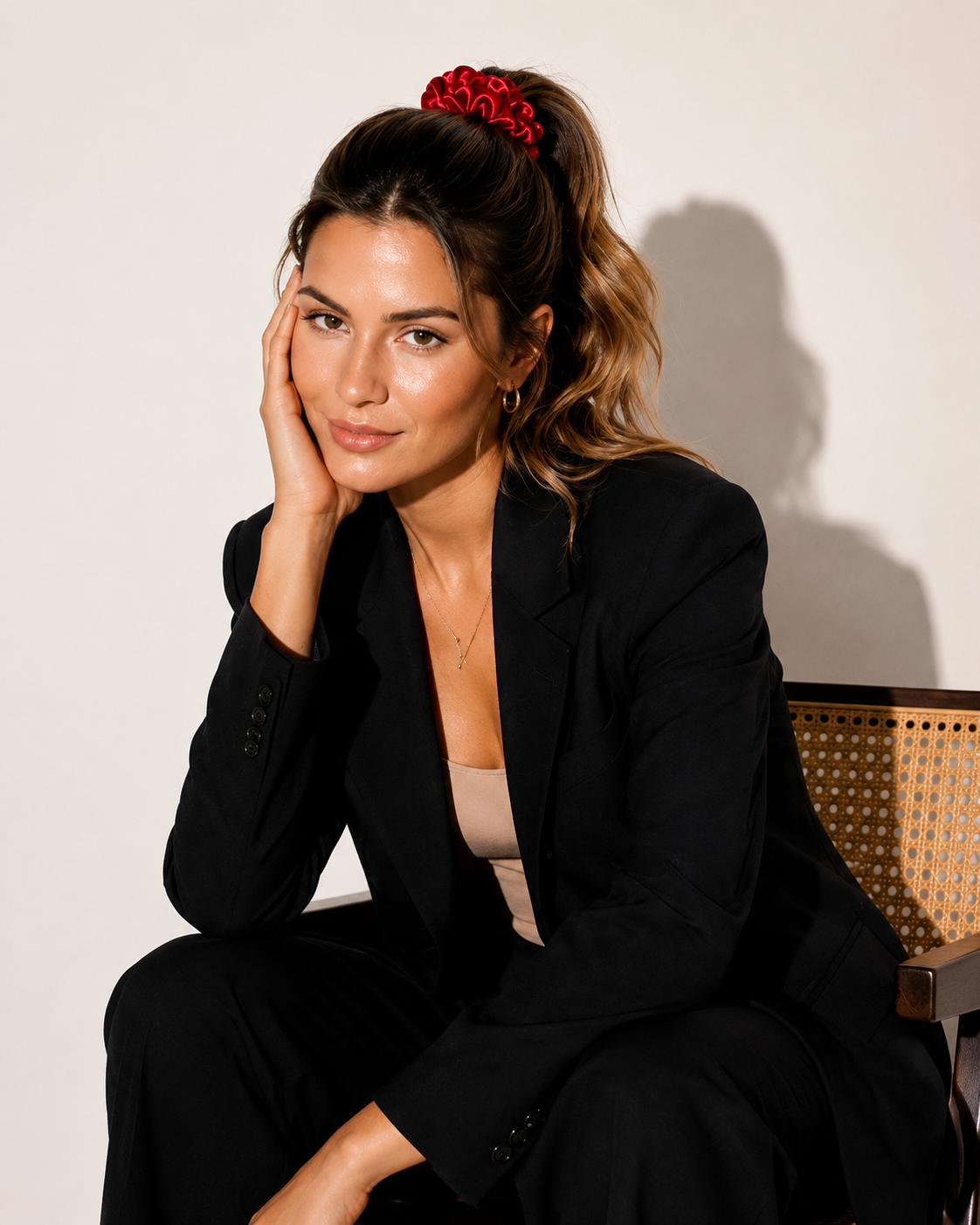 Model wearing BUNLUV red satin scrunchie and black suit