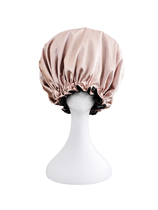 rose gold and black satin bonnet on a white mannequin head against a white background