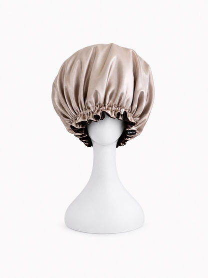 dark chocolate rose gold satin bonnet on a white mannequin head against a white background