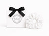 White swim scrunchie by BUNLUV, shown with gift box