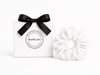 White swim scrunchie by BUNLUV, shown with gift box