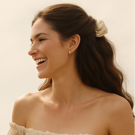 one elegant woman in australian inspired bohemian fashion holding hands and laughing, wearing luxury scrunchies